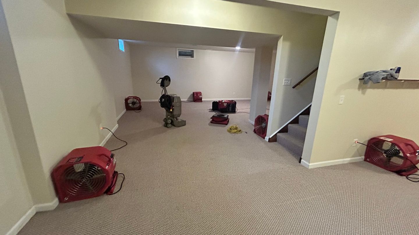 Air movers arranged across a room during restoration
